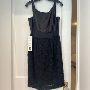 NWT black cocktail dress with lace bottom and bow detail at the waist. Size 8.